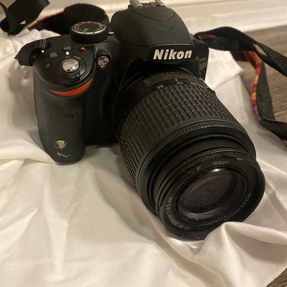 Nikon D3200 camera with battery pack and 55-200 mm lense